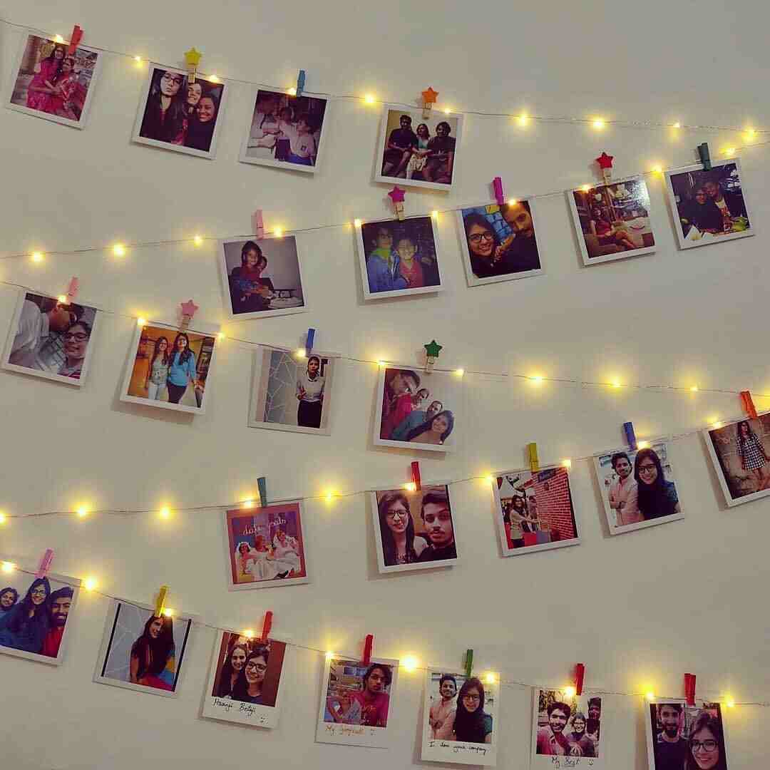 Photo prints displayed with fairy lights