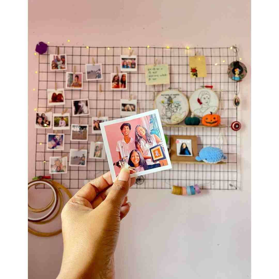 Square photo prints arranged in a wall grid