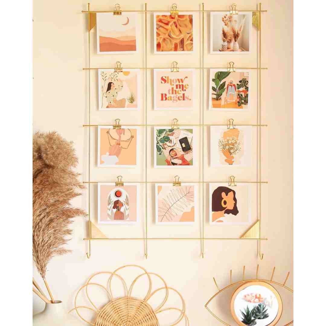 Black and white photo prints arranged on a bedroom wall