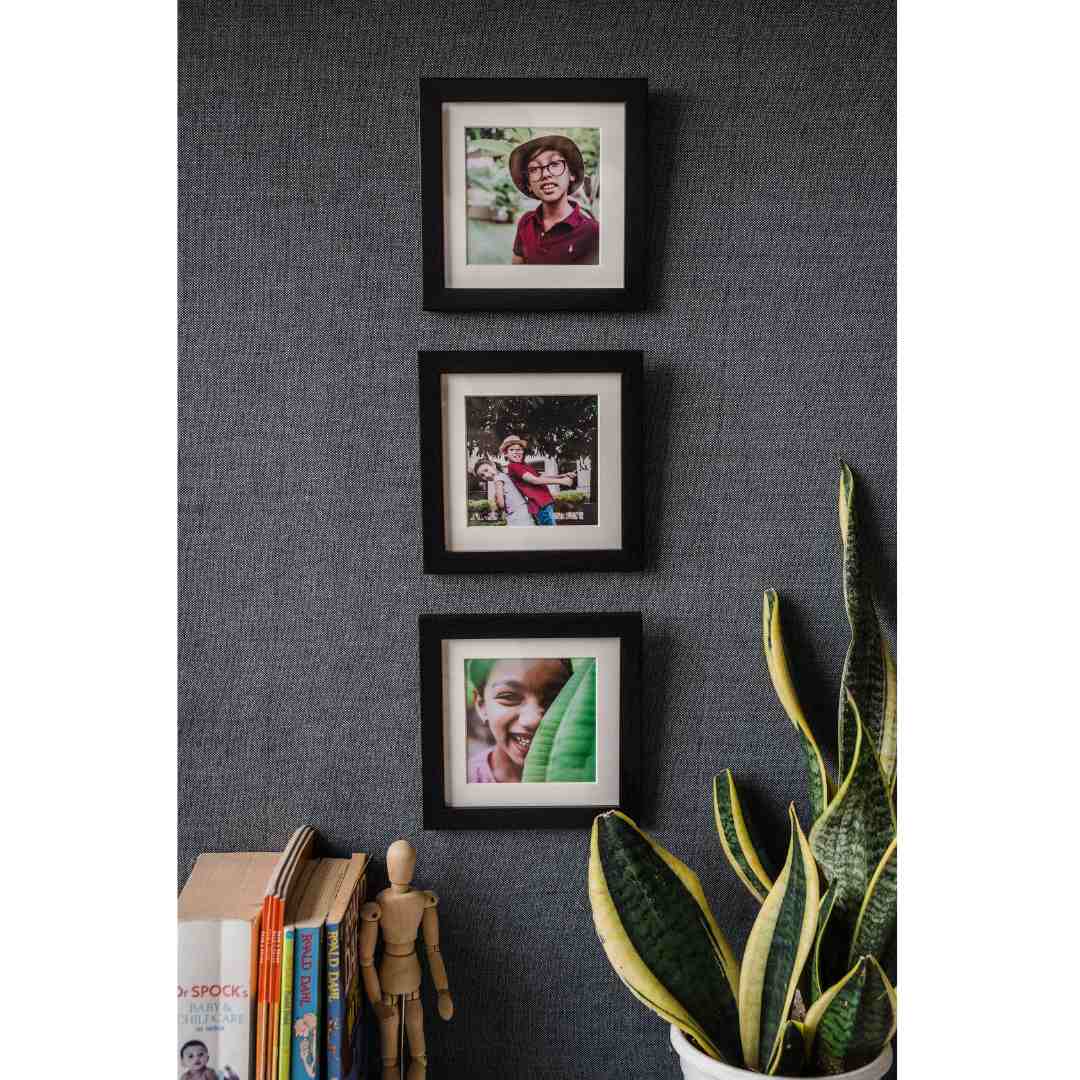 Vertical framed photo display for narrow wall space