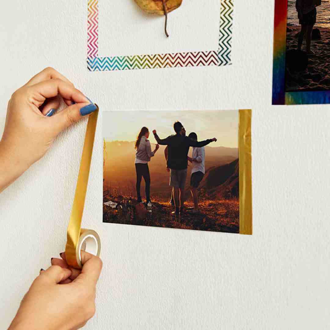Photo prints displayed with colorful washi tape