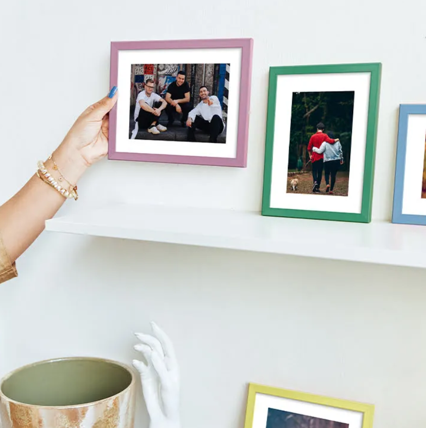 Personalized photo frames with printed memories displayed on a wall