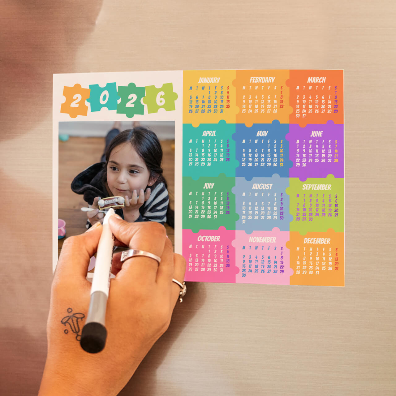 Personalised 2027 magnet calendar used in a kitchen