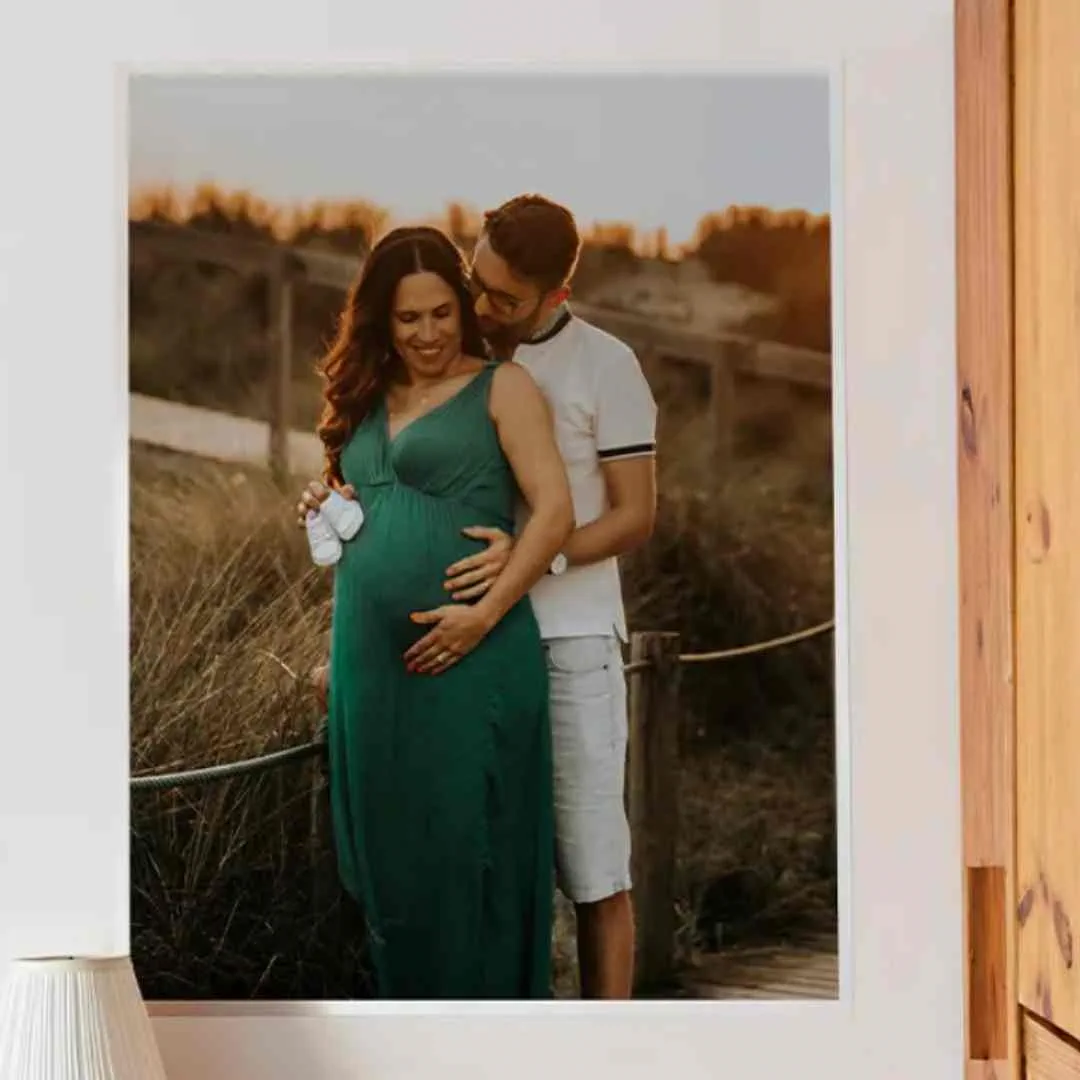 Parents holding tiny baby shoes in a baby shower photo pose