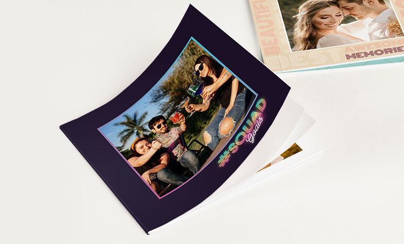 Friends looking through a personalized photobook filled with shared memories